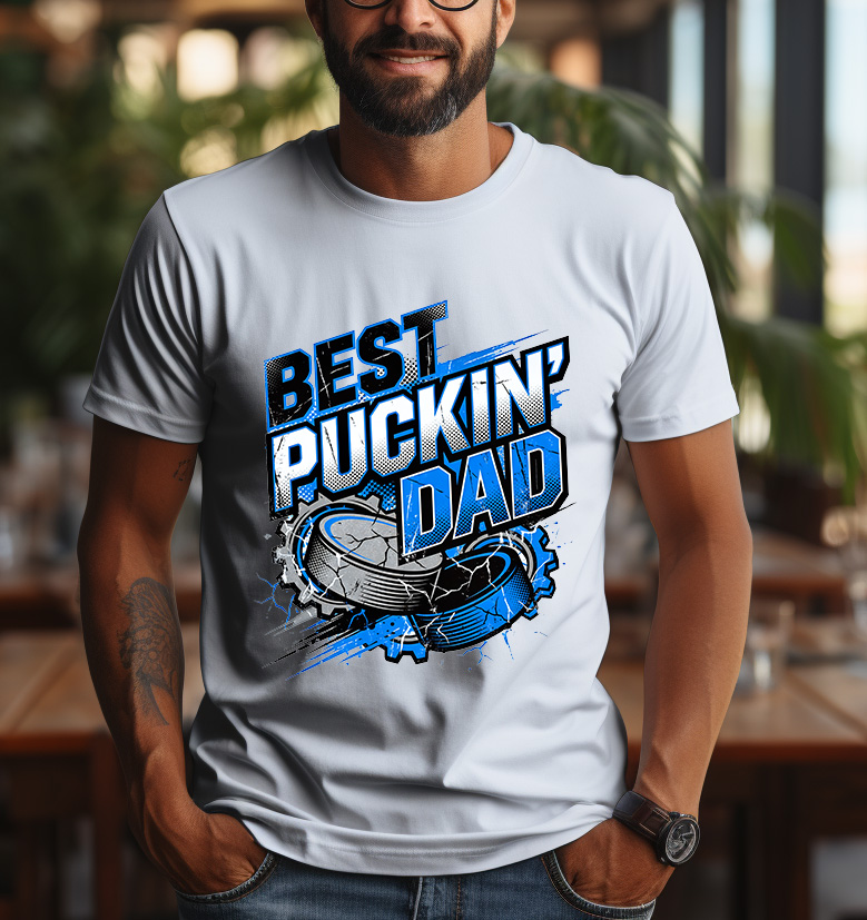 Best Puckin Dad sublimation design with bold blue and black varsity text, cracked hockey puck, and energetic sports graphics